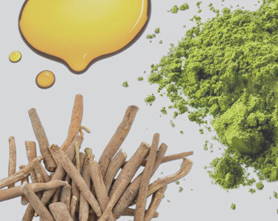Herbal sticks, green powder, and droplets of yellow oil on a light background.